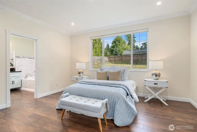 a bedroom with a bed and wooden floor