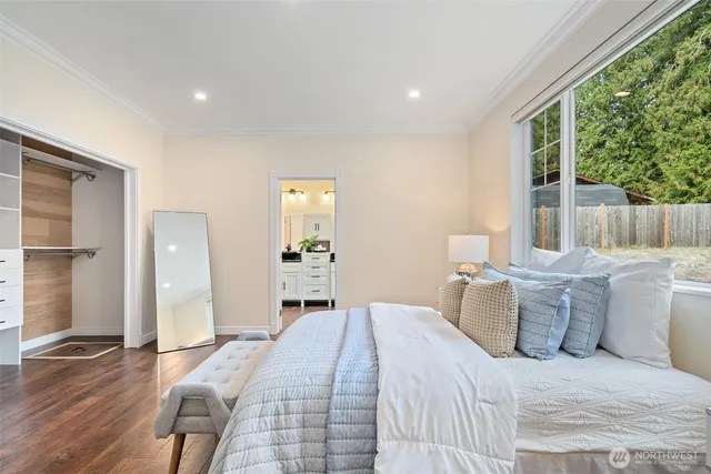 a bedroom with a bed and wooden floor