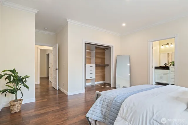 a bedroom with a bed and a potted plant