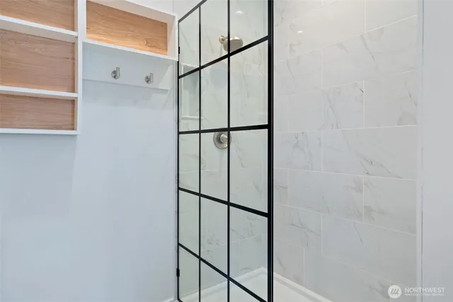 a bathroom with a glass shower door