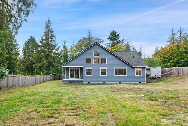 a view of a house with a yard and potted plants