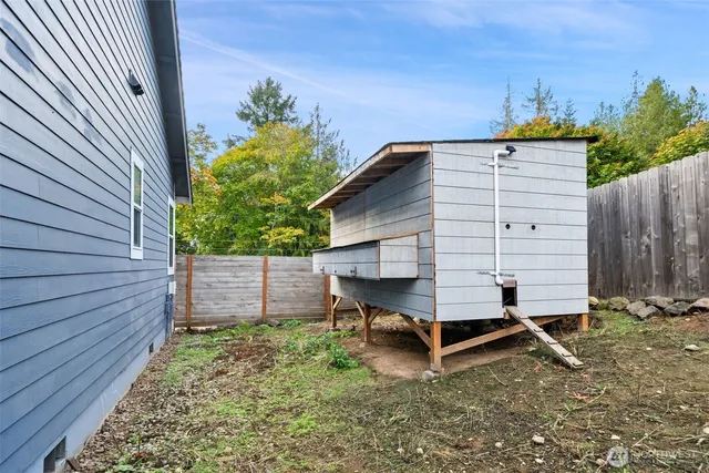 a view of a backyard with wooden fence