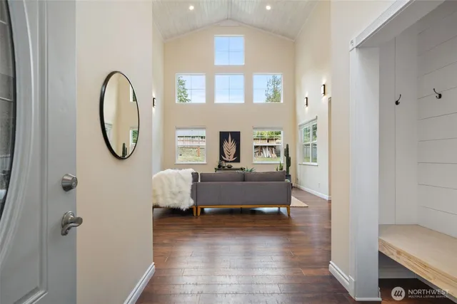 a living room with furniture and a mirror
