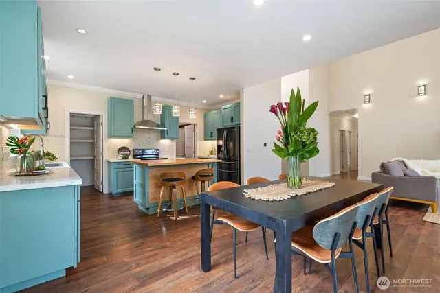 a dining room with furniture and wooden floor