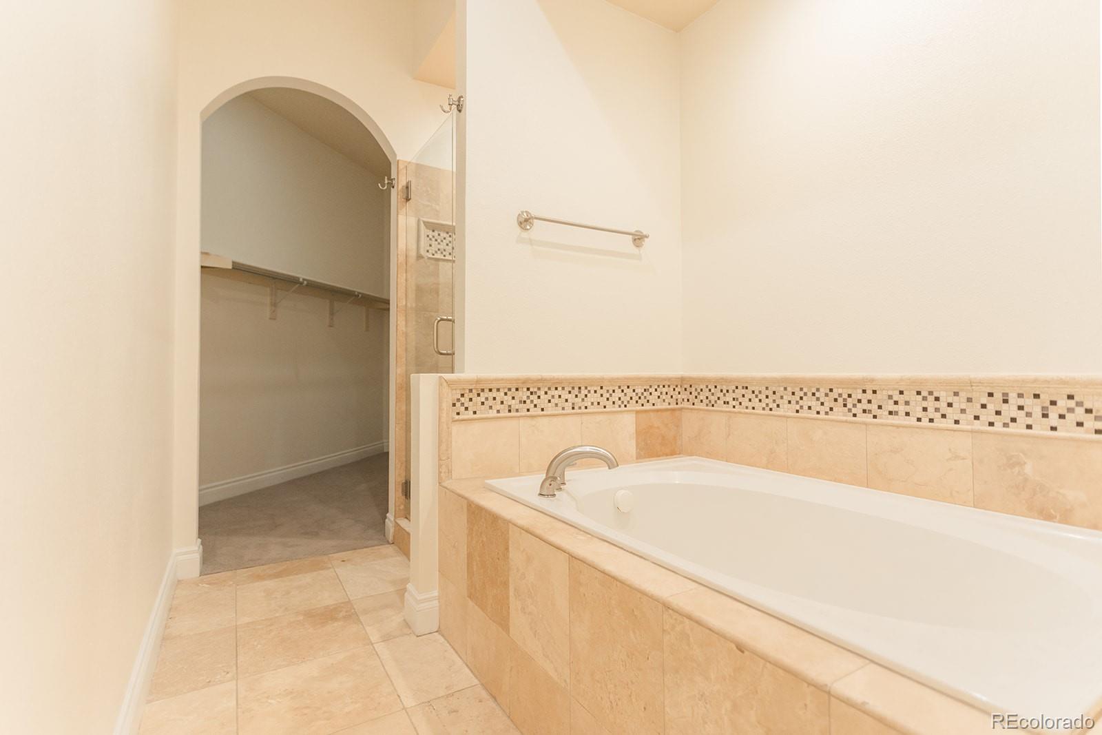 1120 Deleware, Unit 504 Denver, CO 80204 - Photo 17 of 29 a bathroom with a bathtub and a shower