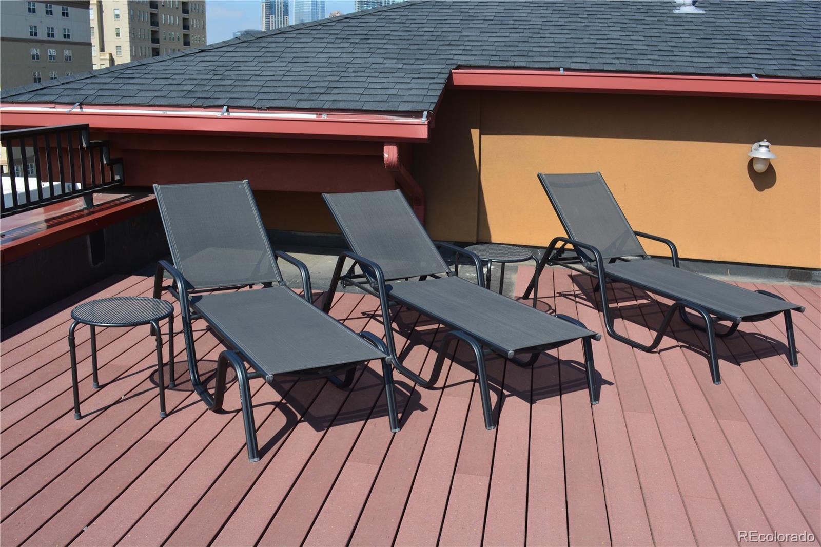 1120 Deleware, Unit 504 Denver, CO 80204 - Photo 27 of 29 a view of a chairs and table on the wooden roof deck