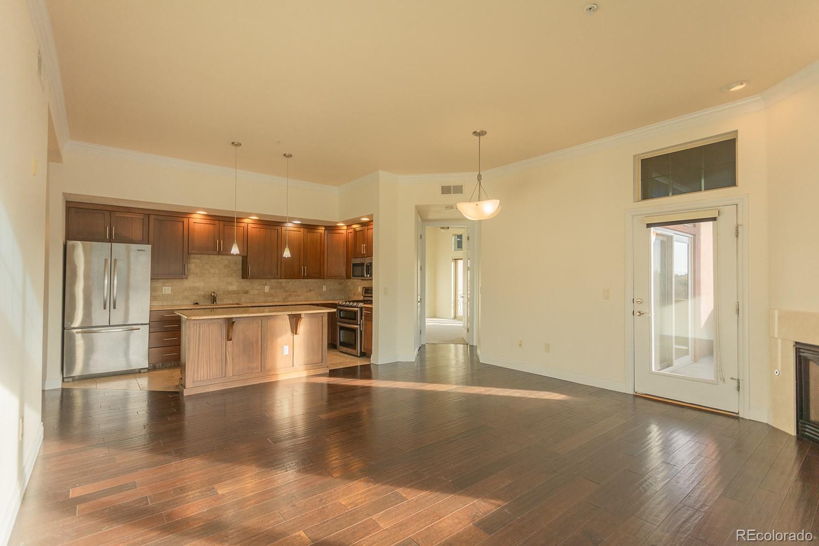 1120 Deleware, Unit 504 Denver, CO 80204 - Photo 5 of 29 a view of a kitchen with a refrigerator and a stove top oven