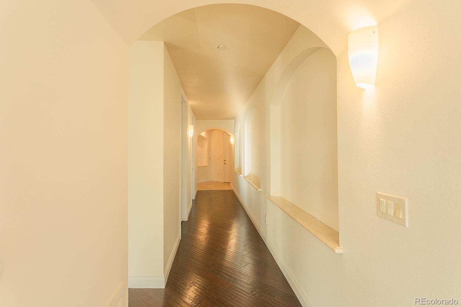 1120 Deleware, Unit 504 Denver, CO 80204 - Photo 8 of 29 a view of a hallway with wooden floor