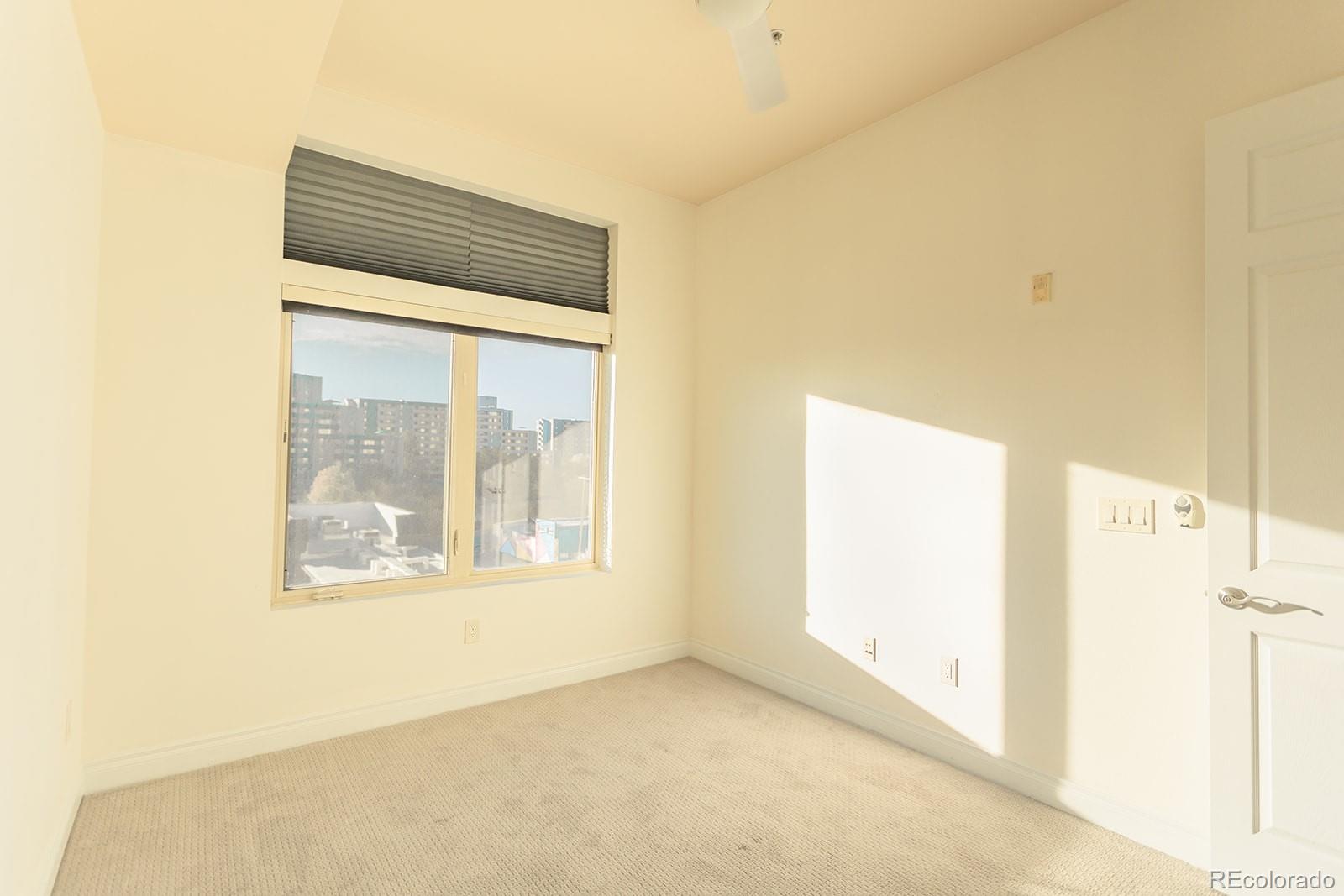 1120 Deleware, Unit 504 Denver, CO 80204 - Photo 9 of 29 a view of an empty room with a window