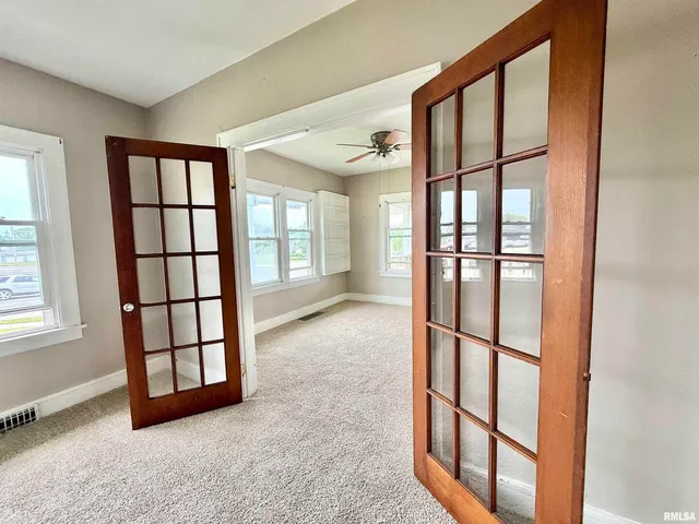 an empty room with windows and closet