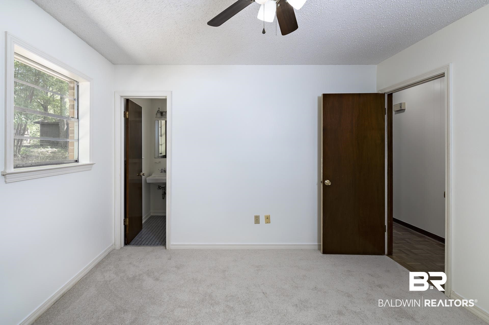 707 Johnson Avenue Fairhope, AL 36532 - Photo 34 of 38 Unfurnished bedroom featuring carpet, a textured ceiling, baseboards, and a ceiling fan