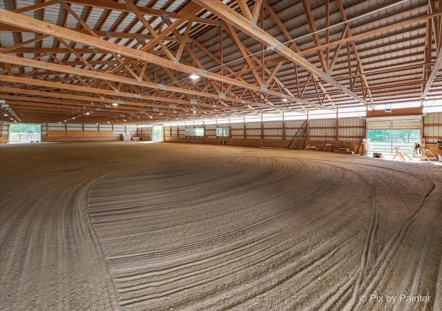 a view of a house with a big yard and potted plants