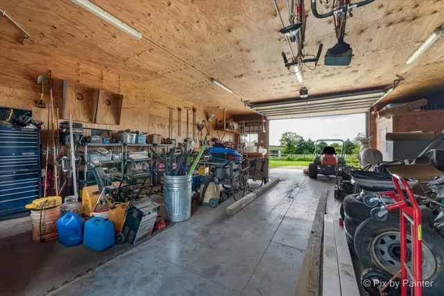 a dining room with furniture large windows and a chandelier