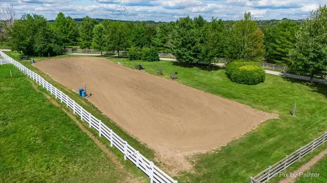an aerial view of residential houses with outdoor space and swimming pool