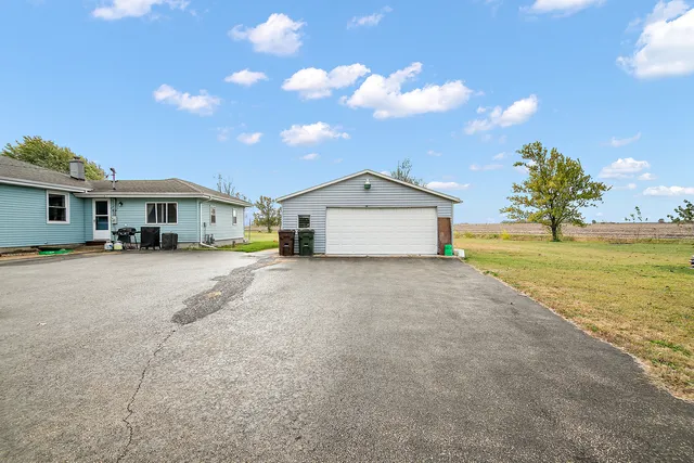 a front view of a house with a yard and ocean view