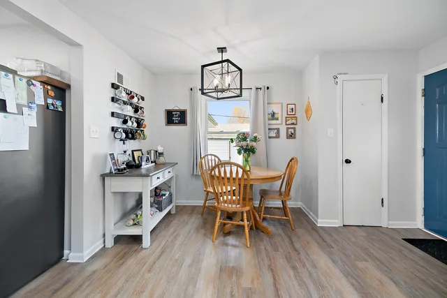 a view of a dining room with furniture wooden floor and a chandelier
