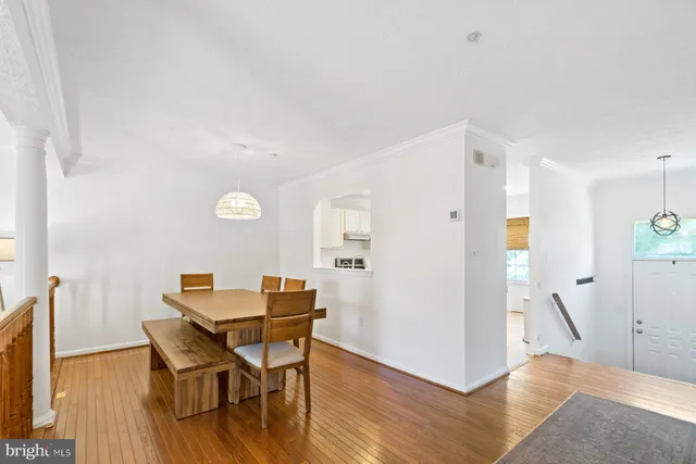 a view of a dining room with furniture and wooden floor