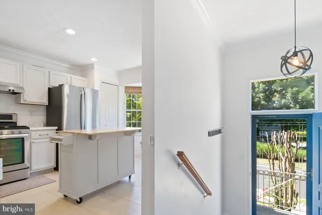 a kitchen with appliances cabinets and a window