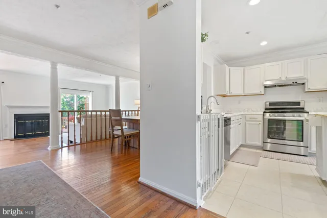 a kitchen with granite countertop a refrigerator and a stove top oven