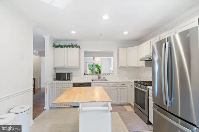 a kitchen with a refrigerator sink and stove