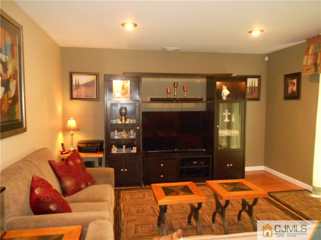 29 Kendall Road Kendall Park, NJ 08824 - Photo 2 of 22 a living room with furniture and a flat screen tv