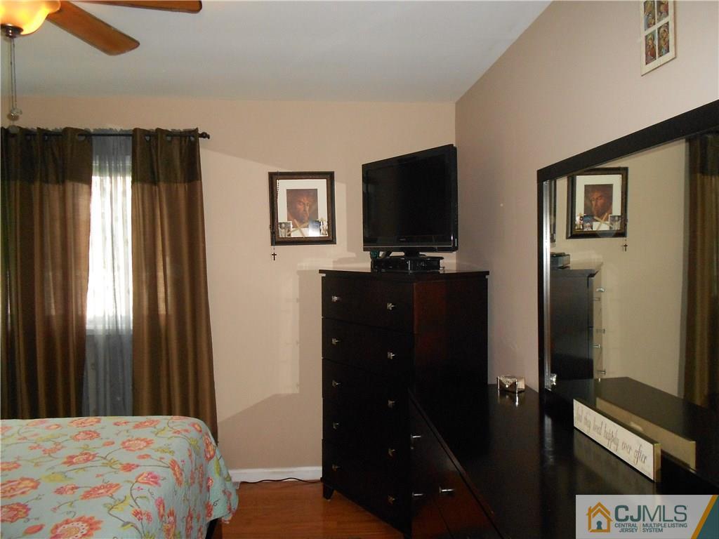 29 Kendall Road Kendall Park, NJ 08824 - Photo 14 of 22 a bedroom with a bed and a flat screen tv