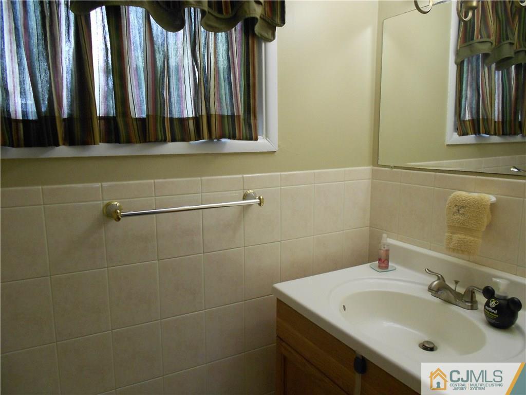 29 Kendall Road Kendall Park, NJ 08824 - Photo 15 of 22 a bathroom with a sink and a mirror