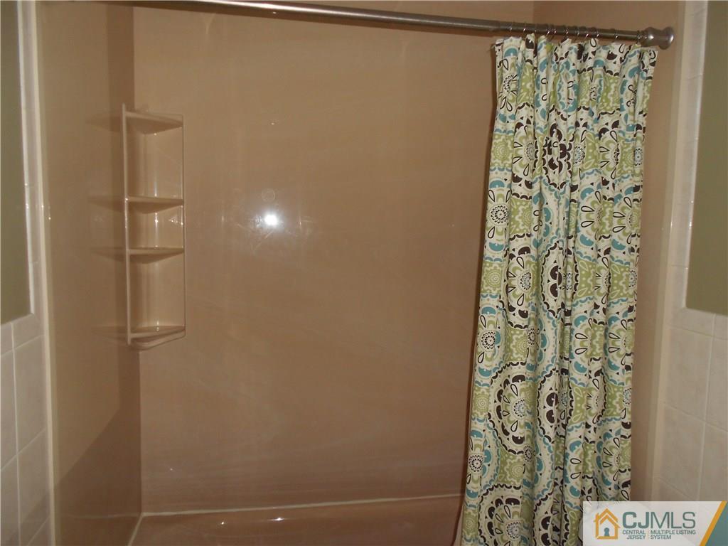 29 Kendall Road Kendall Park, NJ 08824 - Photo 16 of 22 a bathroom with a shower curtain and a shower curtain