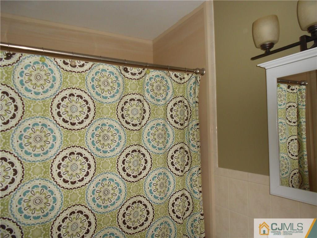 29 Kendall Road Kendall Park, NJ 08824 - Photo 17 of 22 a wall with a clock on the wall and a picture on the wall