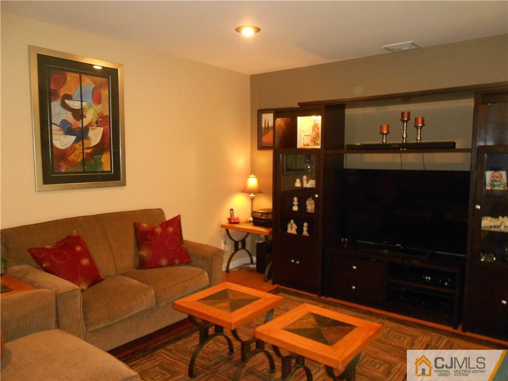29 Kendall Road Kendall Park, NJ 08824 - Photo 3 of 22 a living room with furniture workspace and a flat screen tv