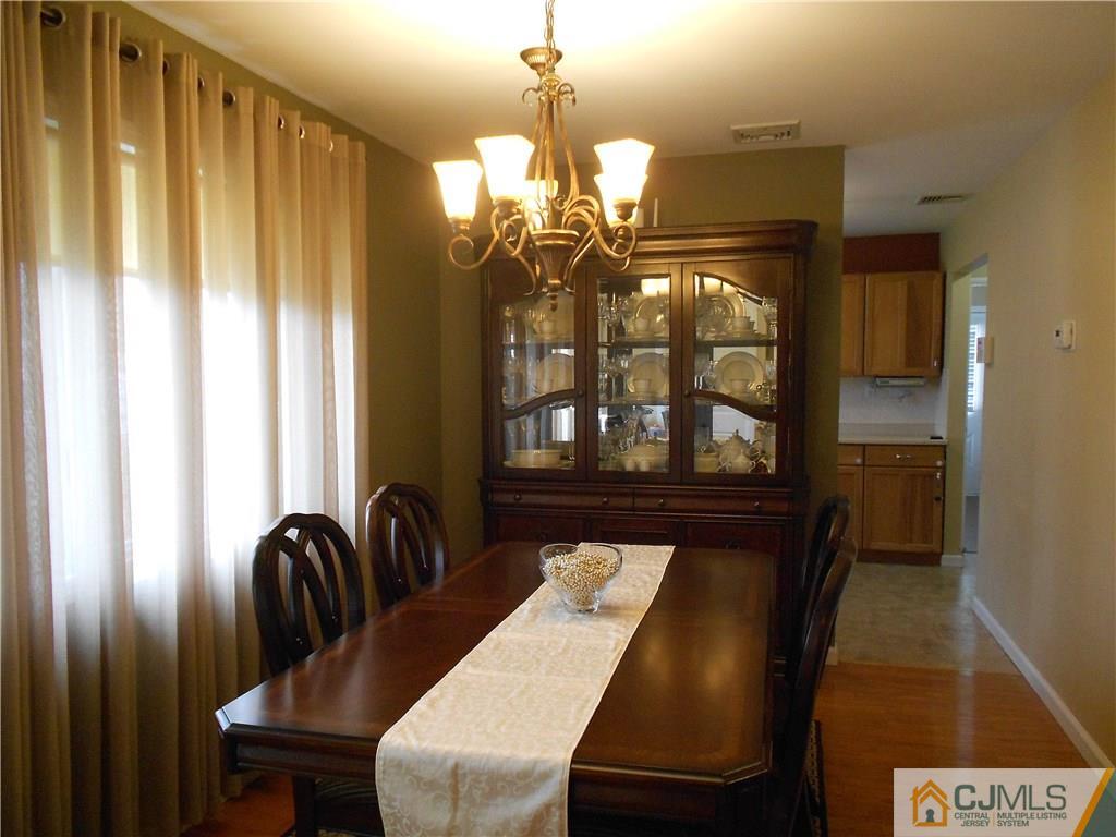 29 Kendall Road Kendall Park, NJ 08824 - Photo 4 of 22 a view of a dining room with furniture and chandelier