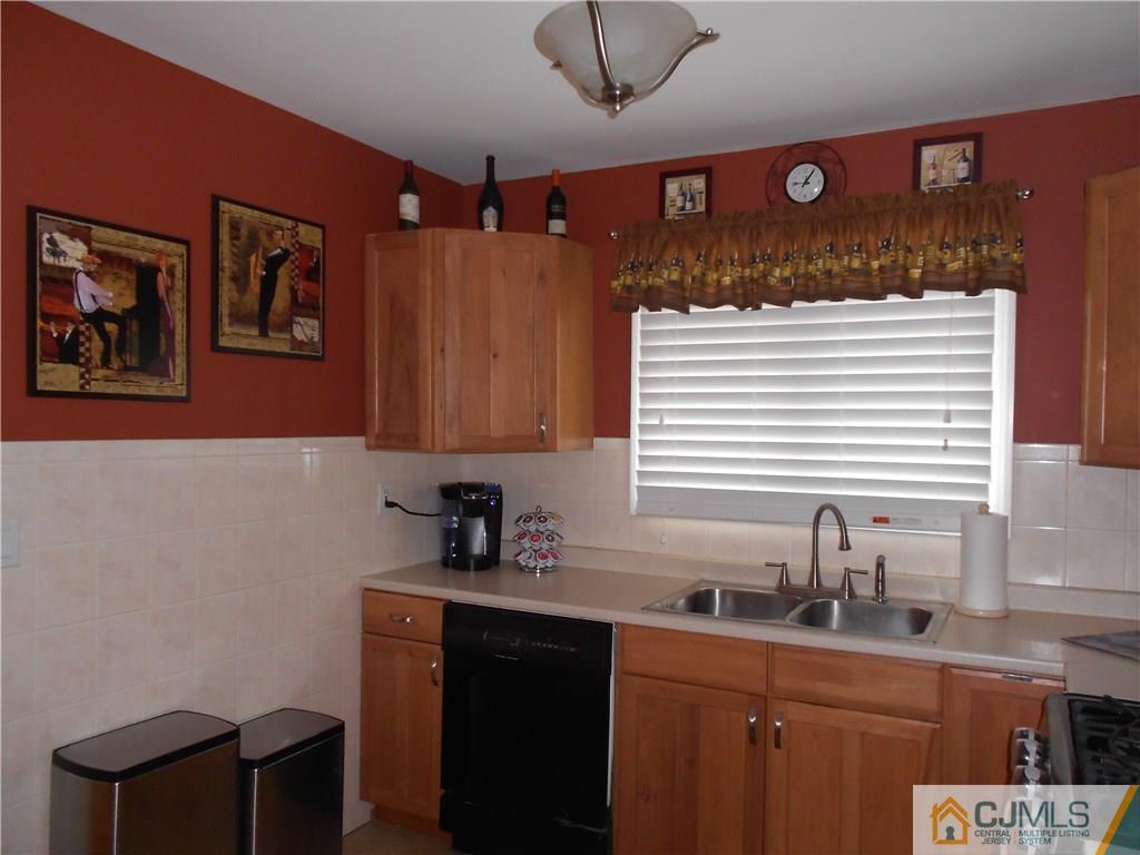 29 Kendall Road Kendall Park, NJ 08824 - Photo 6 of 22 a kitchen with stainless steel appliances a sink a stove a refrigerator and cabinets