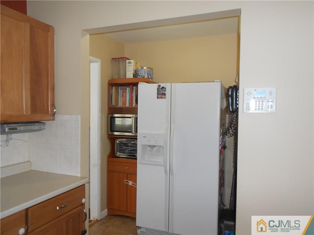 29 Kendall Road Kendall Park, NJ 08824 - Photo 7 of 22 a white refrigerator freezer sitting in a kitchen