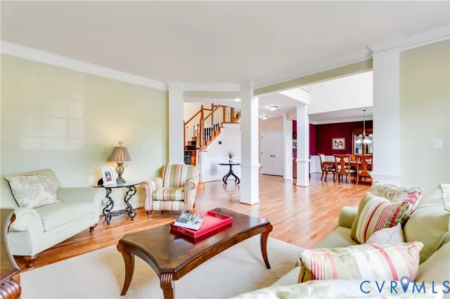 a kitchen with stainless steel appliances wooden floors wooden cabinets a refrigerator and a sink