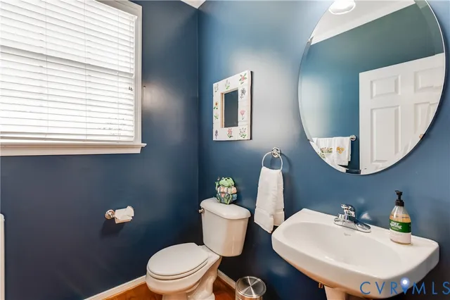 a kitchen with stainless steel appliances granite countertop a sink a stove and a wooden floors