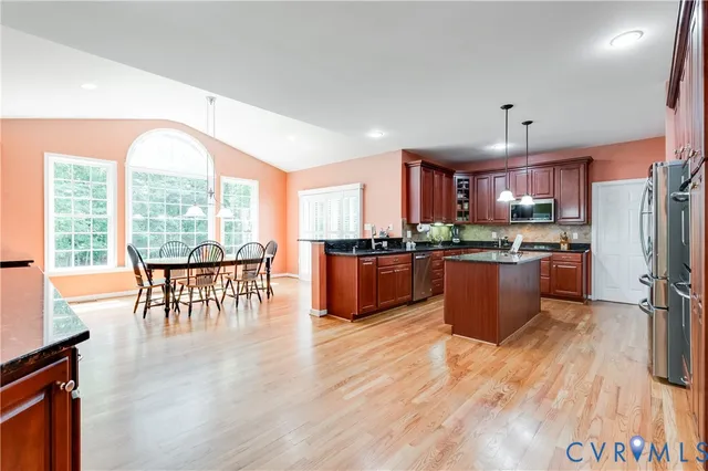 a bedroom with a bed a table and a chandelier