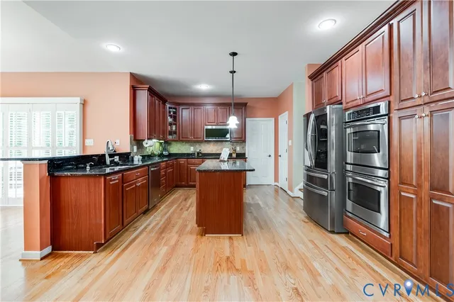 a view of a hallway with wooden floor and entryway
