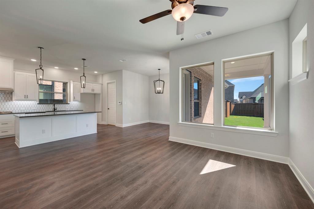 1857 Lightner Road Van Alstyne, TX 75495 - Photo 26 of 29 a view of an empty room and kitchen with wooden floor