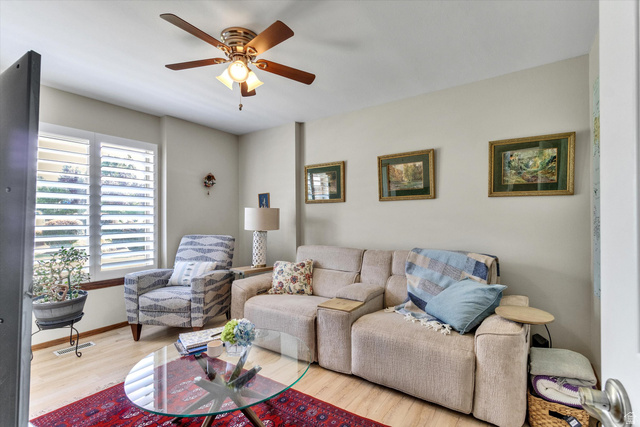 2863 Fallentine Road Sandy, UT 84093 - Photo 24 of 48 Living area featuring wood-finish flooring, a ceiling fan with integrated lighting, and white plantation shutters