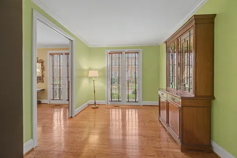 a view of a room with wooden floor and staircase