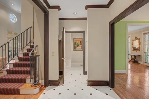 a view of a hallway with furniture and wooden floor