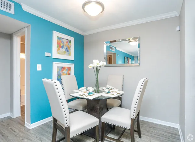 a dining room with furniture and wooden floor