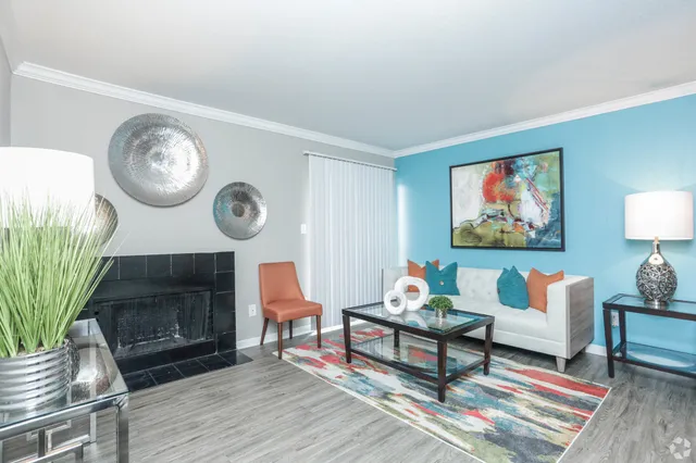 a living room with furniture a rug and a wall painting