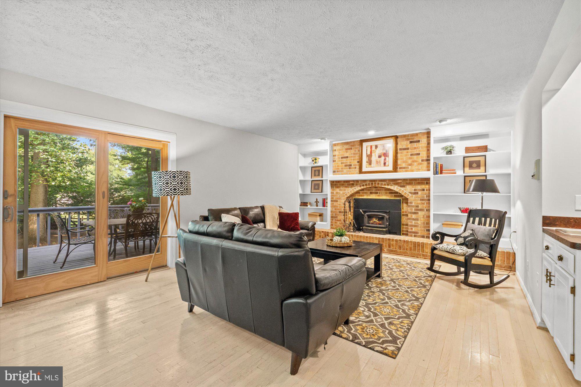 10100 Lawyers Road Vienna, VA 22181 - Photo 19 of 41 Brick fireplace in Family Room w/ doors to back