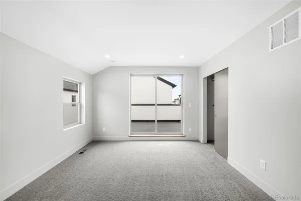 a big room with closet and windows