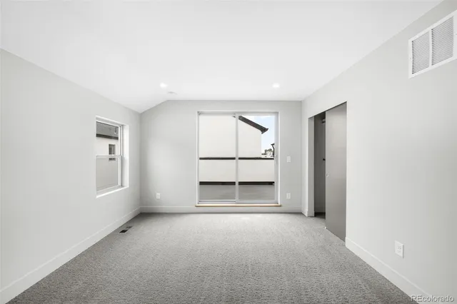 a big room with closet and windows