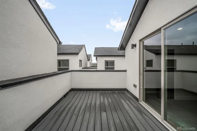 a view of walk in closet with wooden floor and small window