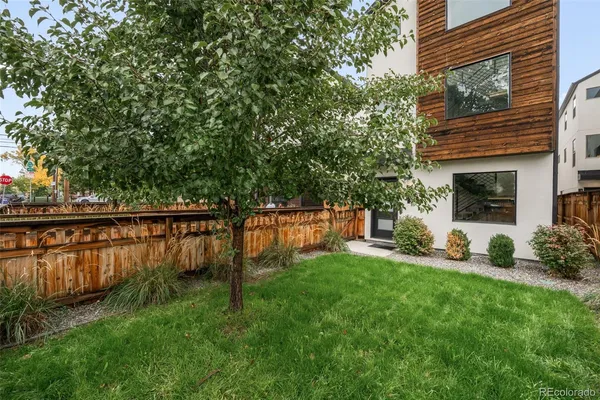 a view of backyard with swimming pool and seating space
