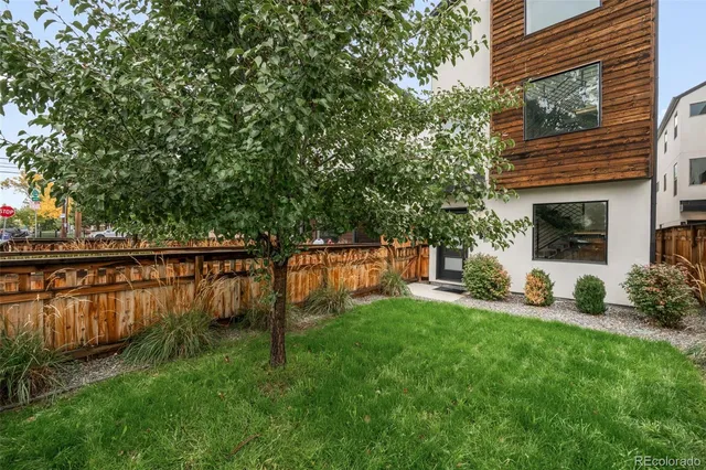 a view of backyard with swimming pool and seating space