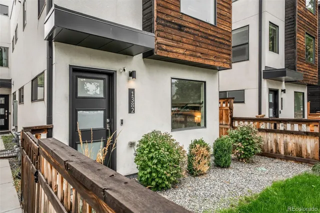 a front view of a house with outdoor seating and plants
